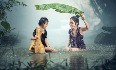 Mãe e filha felizes dentro de um córrego